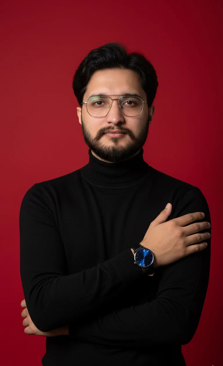 Damodar in a black turtleneck against a red backdrop
